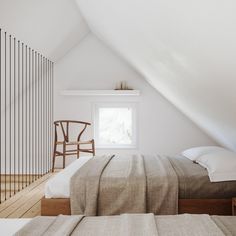 a bed sitting under a window in a bedroom next to a wooden desk and chair