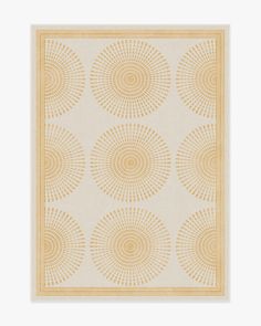 a beige and yellow area rug with circles on the bottom, in front of a white background