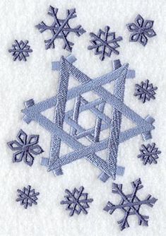 snowflakes are arranged in the shape of a star on a white surface with blue thread