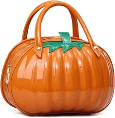 an orange handbag with a green bow on the front and bottom handle, sitting in front of a white background