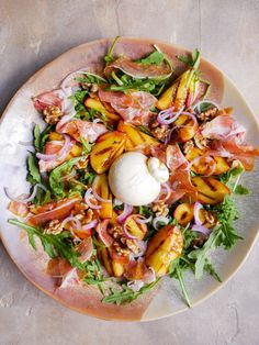 a white plate topped with salad and toppings