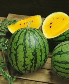 watermelon cut in half on a wooden table