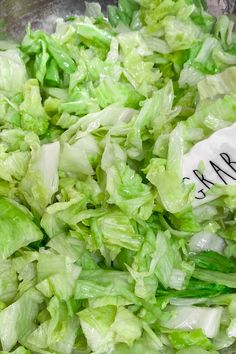 lettuce being cooked in a pan with a spatula