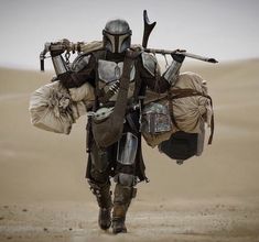 a man dressed as boba fett walking in the desert