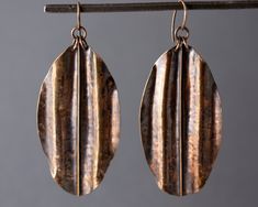 "Hammered, folded. and shaped Bronze on a Bronze ear wire. Dimensions: Width at widest point 1 5/16\" (33 mm), length from top of ear wire to bottom of earring 3 1/8\"(80 mm). Please note, these are individually created, so small variations from originals may be seen." Cheap Bronze Drop Earrings, Unique Bronze Earrings At Cheap Price, Luxury Hand Forged Bronze Earrings, Cheap Elegant Bronze Earrings, Cheap Bronze Metal Earrings, Cheap Unique Bronze Earrings, Luxury Bronze Copper Jewelry, Cheap Bronze Jewelry With Ear Wire, Black Cat Superstition