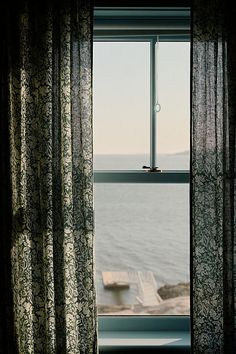 an open window looking out at the ocean