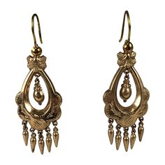 Victorian gold filled articulated long earrings in the Renaissance Revival taste. Gold filled metal has incised foliate motifs with two center hanging urns with small pendant drop fringes and french wire hooks. Excellent Condition. 1880's. L 1.3/4" x W 3/4" Antique Historical Drop Earrings, Antique Jewelry With Historical Design Drop Earrings, Antique Jewelry Drop Earrings With Historical Design, Antique Drop Earrings With Historical Design, Victorian Style Ceremonial Dangle Earrings, Victorian Chandelier Dangle Earrings For Formal Occasions, Antique Ceremonial Dangle Earrings, Antique Dangle Earrings For Ceremonies, Antique Formal Dangle Chandelier Earrings