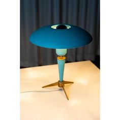 a blue table lamp sitting on top of a white counter