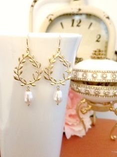 "The Romantic chandelier earrings feature gold laurel wreaths with tiny leaves, accented with SWAROVSKI teardrop pearl. The swarovski pearl measure 10mm x 13mm. Total length of these earrings is approx. 2 1/4\" (57mm) including gold plated French hook ear wires. The necklace length is 16\"+2.5\" extender This beautiful pair of Earrings is packaged in a gift box. All items come wrapped individually in a ribboned gift box. ♥ ♥ ♥ ♥ ♥ ♥ ♥ ♥ ♥ ♥ ♥ ♥ ♥ ♥ ♥ ♥ Enter my boutique here: http://www.LaLaCrys Delicate Gold Earrings For Bridal Shower, Delicate Gold Hoop Earrings For Wedding, Gold Dangle Earrings For Bridal Shower, Gold Delicate Pearl Earrings For Bridesmaid, Gold Hoop Earrings With Ear Wire For Wedding, Gold Earrings For Bridal Shower, Elegant Gold Bridal Earrings For Wedding Gift, Delicate Yellow Gold Hoop Earrings For Wedding, Dainty Gold Hoop Earrings For Wedding