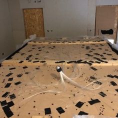 an unfinished bed frame with black and white tiles on it