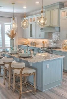 a kitchen filled with lots of counter top space next to a dining room table and chairs