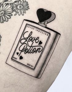 a woman's thigh with a tattoo on it that reads love station and flowers