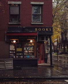 a book store sitting on the side of a street next to a red brick building