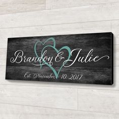 a wooden sign that says brandy and julia, with two hearts in the center on it