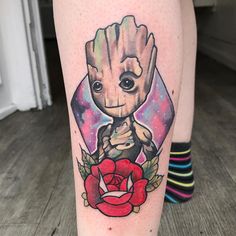 a tattoo on the leg of a person with an image of a baby groote