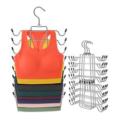 an orange bra hanging on a clothes rack next to several pairs of multicolored bras