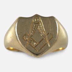 An Edwardian 18ct yellow gold signet ring, hallmarked for 1905. This signet ring features a shield-shaped head with an engraved Masonic emblem, complemented by plain shoulders and shank. * Assay: Chester assay office marks, '18' for 18 carat gold. * Period: Early 20th century. * Maker: Samuel Usher Ltd. * Measurement: UK ring size W 1/2, US ring size 11 1/4. The head measures 14.8mm by 13.5mm. * Weight: 12.5 grams. Condition: The ring is in good antique condition with light scratches and minor p Gold Signet Ring, Chains For Men, Signet Ring, Antique Collection, Early 20th Century, Chains Necklace, Antique Jewelry, 20th Century, Mens Jewelry