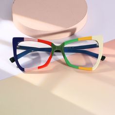 Elevate your urban chic style with our Personalized Cat Eye Full Rim Acetate Eyeglasses. Featuring a cat-eye shape and a unique multi-color patchwork, these glasses are a true fashion statement. The vibrant and individualistic colors add a touch of personality and modernity to your look, making them an essential accessory for any outing. Designed by renowned fashion designers, these glasses are a testament to your impeccable taste and love for all things trendy. Let them be your go-to item for a fashionable and confident urban look, exuding sophistication and style wherever you go.Weight: 22.5 gFrame Shape: Cat EyeFrame Color: Green, Blue, Beige, MulticolorFrame Material: AcetateRim Type: Full RimSpring Hinge: NoAdjustable Nose Pads: NoWeight: 22.5 gLens Width: 55 mmBridge Width: 17 mmTemp Urban Chic Style, Statement Glasses, Unique Glasses Frames, Green Glasses, Eye Green, Eyeglasses 2024, Let Them Be, Urban Chic Fashion, Fashion Eyeglasses