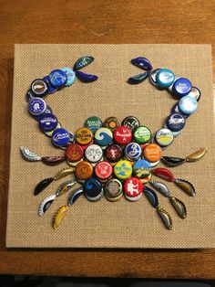 a crab made out of bottle caps sitting on top of a table