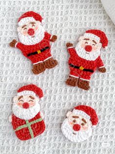 crocheted santa clause ornaments on a bed