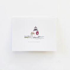 a white card with a red wreath and a light house on it's side