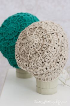 two crocheted balls sitting on top of each other