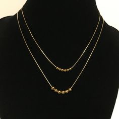 ❤️❤️❤️ On Sale 20% off and Free Shipping ❤️❤️❤️ Customized 14k gold filled bead necklace. You choose length, size and number of beads. Made to order from 14-20 inches with 3mm or 4mm beads. Beads, chain and all components are 14k gold filled - not gold plate. Gold filled jewelry is high quality and does not tarnish. These are free sliding beads and you may choose the size, as well as the number of beads. Please message me for quantities of beads not listed here. Packaged in a complimentary broca Minimalist Gold Beaded Necklaces With Tiny Beads, Yellow Gold Necklaces With Tiny Beads For Everyday, Minimalist Tiny Beaded Necklaces For Layering, Gold Jewelry With Tiny Beads For Layering, Minimalist Beaded Chain Layered Necklace As Gift, Everyday 14k Gold-filled Necklaces With Tiny Beads, Everyday 14k Gold Filled Tiny Beads Necklace, Gold Layered Necklace With Round Beads, Everyday 14k Gold-filled Necklace With Tiny Beads