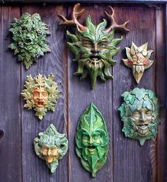 a wooden door with many different masks on it