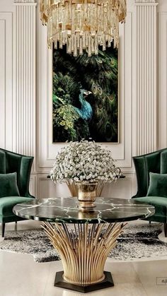 a living room filled with furniture and a chandelier hanging from the ceiling next to a painting