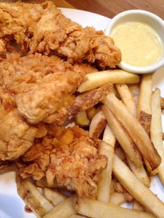 fried chicken and french fries on a white plate