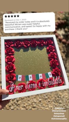 someone is holding up a card with roses in it