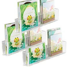 four clear acrylic boxes with cards and envelopes in each box, featuring a frog