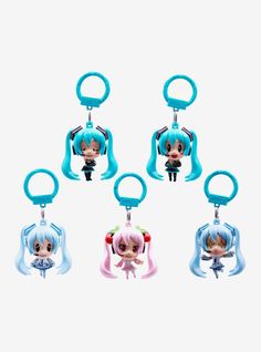 four keychais with anime characters on them, one is blue and the other has pink