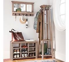 a coat rack with shoes and purses on it in front of a window next to a door