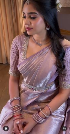 a woman in a pink sari sitting down