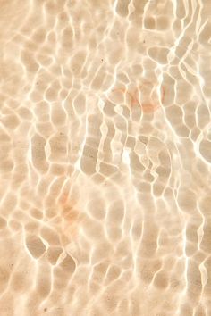 an orange object floating on top of a body of water next to a sandy beach