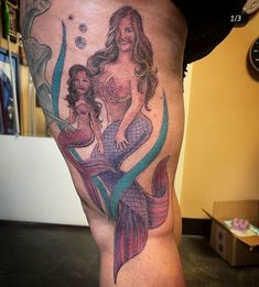 a woman with a mermaid tattoo on her leg