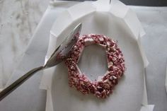 a white plate topped with food and a fork next to it on top of a table