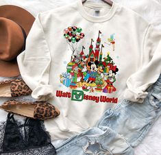 White Letter Print Sweatshirt For Disney Fan Events, White Letter Print Sweatshirt For Disney Events, White Graphic Print Sweatshirt For Disney Fan Events, Disney White Christmas Tops, Disney White Sweatshirt With Cartoon Print, Disney Cotton T-shirt For Winter, Disney White Cartoon Print Sweatshirt, White Disney Character Print Sweatshirt For Fan Events, White Disney Cartoon Print Sweatshirt