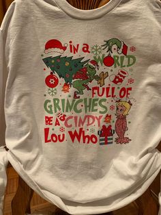 Get into the Christmas spirit with this super cute long sleeved graphic tee. In A World Of Grinches Be A Cindy, Cindy Lou Who Jewelry, Cindy Lou Who Tshirt, In A World Full Of Grinches Be A Cindy Lou Who, Grinch Christmas Shirt Teepublic, Cindy Lou Who, Cindy Lou, In A World, Graphic Tees Women