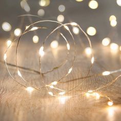 some lights that are on top of a wooden table in front of a blurry background