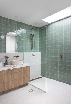 a bathroom with two sinks and a shower