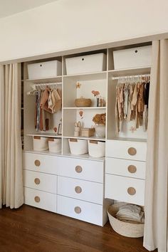 an organized closet with white drawers and beige curtains