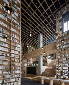 the interior of a library with wooden bookshelves and benches in front of them