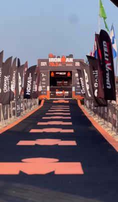 the race track is lined with flags and banners on both sides, as well as an exit way