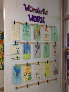 a bulletin board with post - it notes and magnets attached to the wall in a classroom