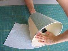 a person is using a large cone to clean the area on top of a cutting board