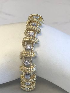 "18kt Yellow Gold Heavy Solid Lady's Cubic Zirconia (CZ) Bracelet 7\" in Length. This Bracelet consists of 18- 3mm, .10ct each , 1.80ctw Cubic Zirconia (CZ) all prong set in 14kt White Gold settings in a heavy solid 12mm wide hinged mounting. There is a hidden box clasp with a secure fig 8 safety clasp. These CZ's look so real. Total mounting weigh is 43.8 grams. This item would Retail for $6,550.00" Dazzling Gold Diamond Bracelet For Anniversary, Dazzling Yellow Gold Diamond Bracelet For Anniversary, Anniversary Dazzling Yellow Gold Diamond Bracelet, Gold Diamond Cut Bracelet With Dazzling Style, Gold Diamond Cut Dazzling Bracelet, Yellow Gold Cubic Zirconia Bracelet For Anniversary, Dazzling Gold Diamond Cut Bracelet, Gold Bracelet With Cubic Zirconia In Prong Setting, Gold Cubic Zirconia Bracelet With Diamond Accents For Anniversary