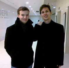 two young men standing next to each other