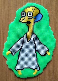 the simpsons character is depicted in this cross - stitch bead art pattern on a piece of wood